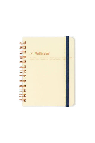 gold spiral notebook with dark blue band, clear cover, and yellow pages