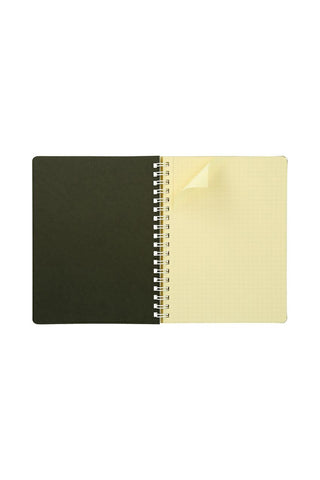 Beige notebook with a spiral binding on a white background