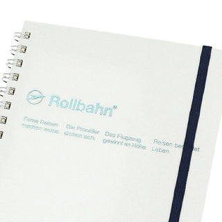 Metallic white notebook with 'Rollbahn' branding and text on a white background