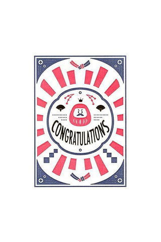 Design with 'Congratulations' text and decorative elements around a Daruma on a white background