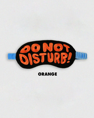Sleep mask with 'Do Not Disturb!' orange text on a white background