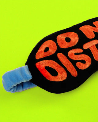 Sleep Mask with 'Do Not Disturb' text on a green background