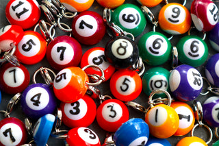 Collection of colorful billiard ball keychains with numbers.