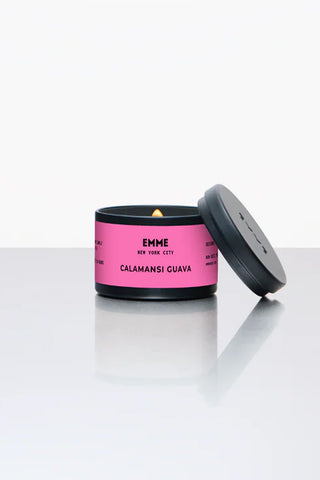 Calmansi Guava scented candle with pink packaging and black lid on a white surface