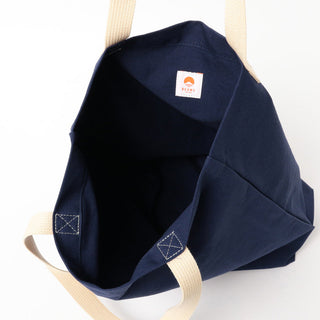 Navy blue bag with beige straps on a white background