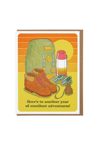 Illustration of hiking gear with a backpack, boots, and thermos on a yellow background with text 'Here's to another year of excellent adventures!'.