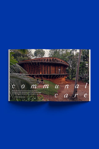 Magazine page with text 'communal care' with a wooden structure and trees on a blue background