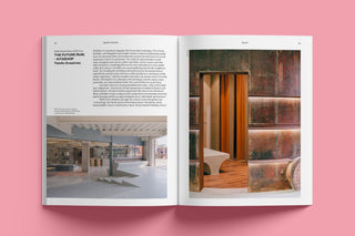 Open magazine showing interior design pages with text on a pink background