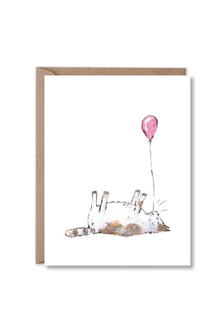 greeting card with illustration of white and orange cat laying on its back with a balloon