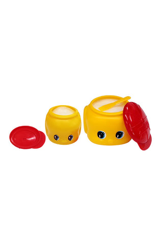 Two opened yellow glue containers with red lids on a white background