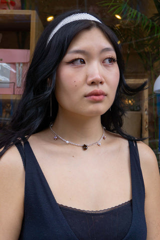 Person wearing Tear Necklace outside