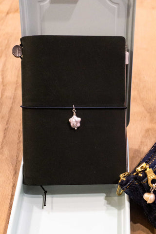 Baby start pearl charm on the front of a notebook 