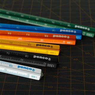 Stack of colored aluminum metric drafting scales: orange, blue, green, and black
