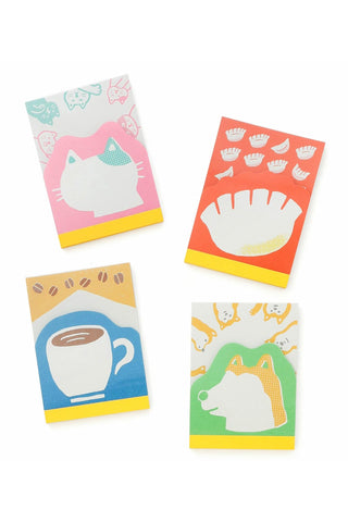 Set of four colorful notepads with retro illustrations on a white background