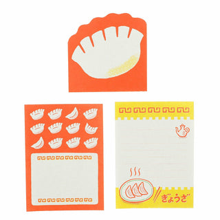 Set of three small notepad sheets with dumpling designs on a white background