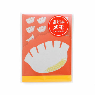 Memo pad with dumpling design on a white background