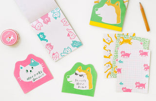 Set of colorful stationery items with cat and dog designs on a white background