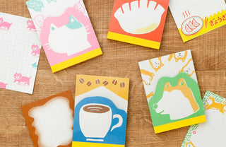 Colorful stationery items with retro illustrations on a wooden surface