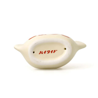 Bottom side of porcelain pen holder with red text on a white background