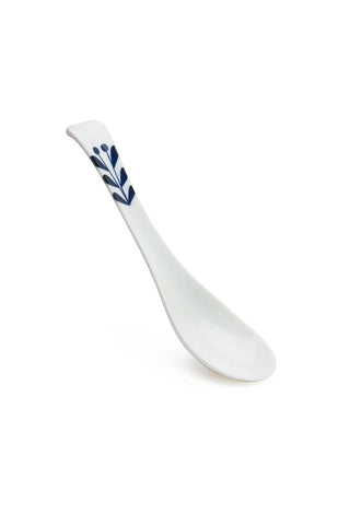 White spoon with blue floral design on a white background