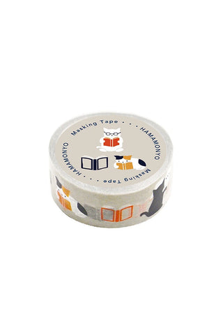 Roll of masking tape with decorative design of a cat reading a book on a white background