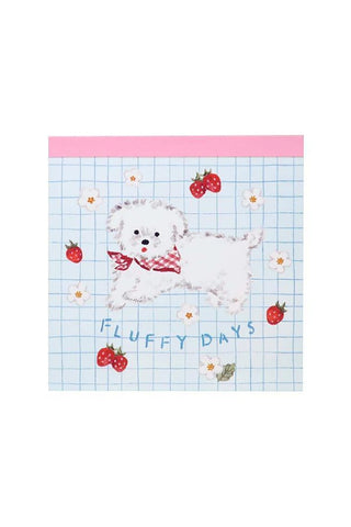 Memo pad with a cartoon dog and strawberry design on a blue grid background