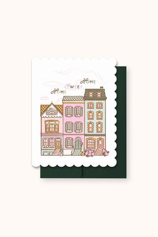 Greeting card with illustration of colorful houses and 'Home Sweet Home' text on a white background.