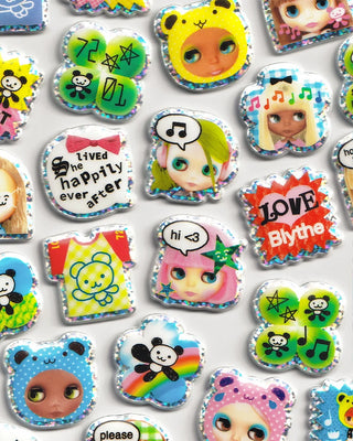 Close-up of puffy character stickers with faces, hearts, and music icons