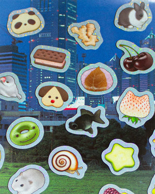 Stickers with various designs on a blue background with cityscape.