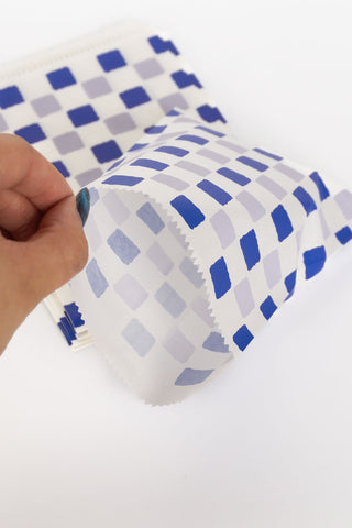 Hand opening flat paper bag on a white background