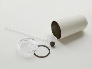 White tumbler with lid, straw, and gasket on a white background