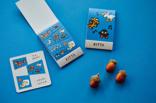 Kitta character stickers on a blue background with acorns.