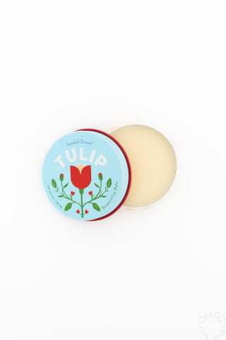 Opened container of Kala Tulip Lip Balm with blue packaging on a white background