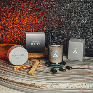 Candle and packaging with 'Icelandic Ash' branding on a textured surface.
