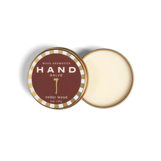 Hand salve in a tin with 'Wood Aromatics Cedar Wood' branding on a white background