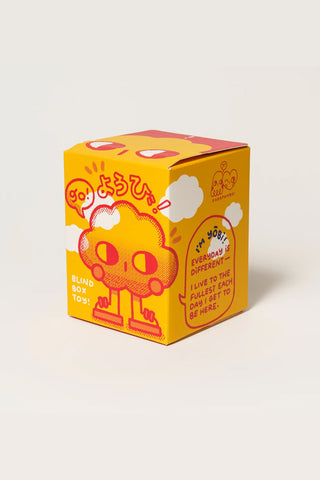 Yellow toy box with cartoon character and text on a light gray background
