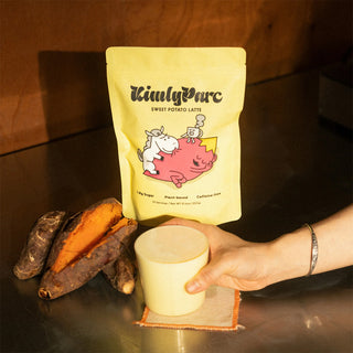 Hand holding a cup of sweet potato latte next to a package labeled 'KimlyParc'e.