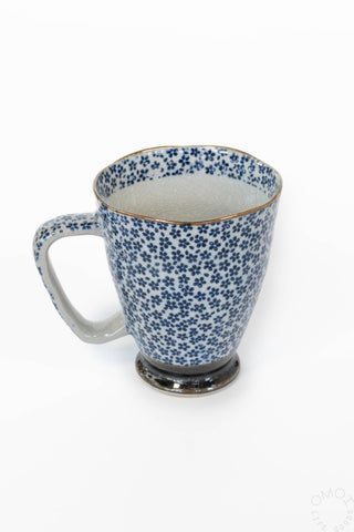 Blue floral-patterned mug on a white background