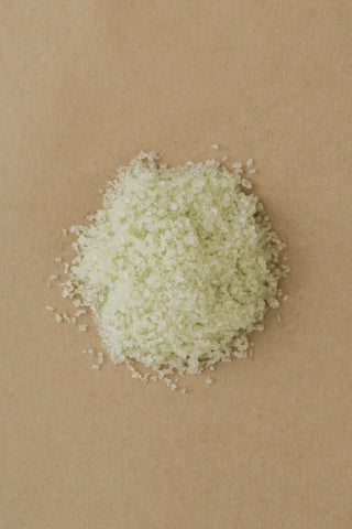 Light green bath salts on a brown background