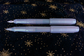 Two Kaweco perkeo pens on a black fabric star background