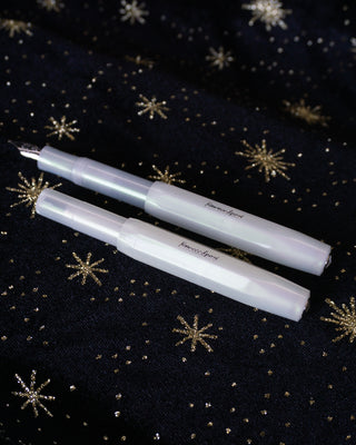 Two Kaweco pens on a black star fabric background