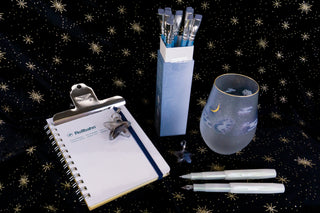 Two Kaweco lunar pens on a black fabric star background with stationery