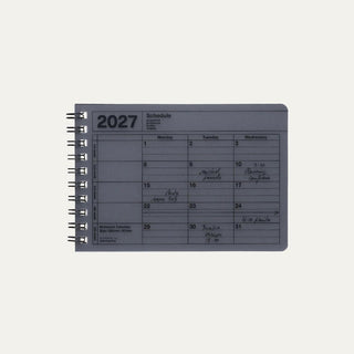 Small black monthly calendar on a light background