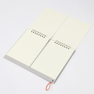 Open notebook with light-colored pages on a white background