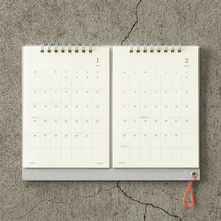 Calendar open to January and February on a textured surface