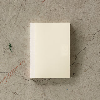 Beige notebook on a textured concrete surface