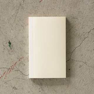 Beige notebook on a textured concrete surface