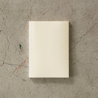 Beige notebook on a textured concrete surface