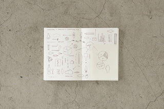 Open book with illustrations on a textured beige surface