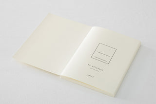 Open notebook with minimalist design on a light gray background